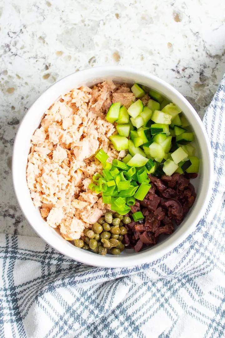No-Mayo Greek Tuna Salad ingredients in a white bowl.